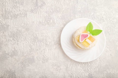 Decorated cake with milk and coconut cream on a gray concrete background. top view, flat lay, copy