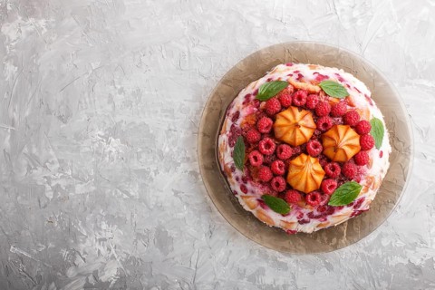 Homemade jelly cake with milk, cookies and raspberry on a gray concrete background. top view. flat