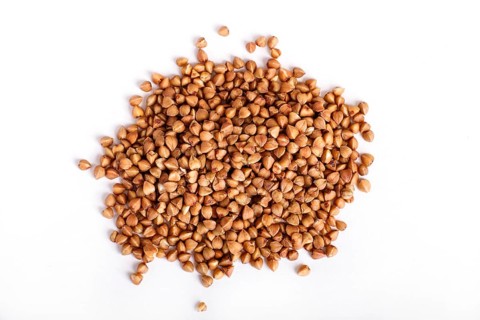 Pile of buckwheat isolated on white background. Top view