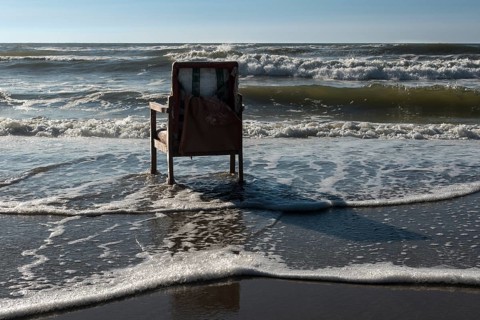 Upholstered chair washed up on the North Sea shore, flotsam, Oksbol, Region Syddanmark, Denmark,