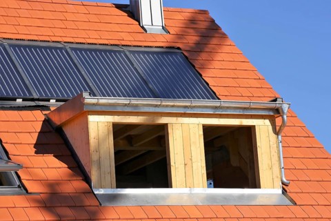 Roofer working on a new dormer window