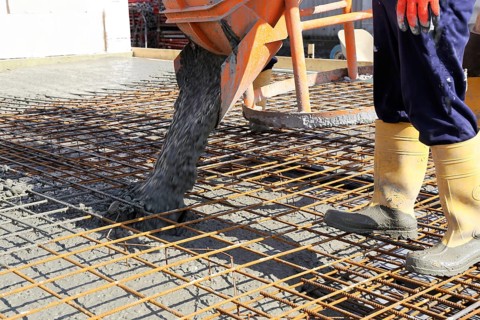 Concreting a floor slab with ready-mixed concrete on the construction site of a residential
