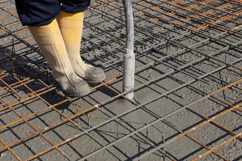 Concreting a floor slab with ready-mixed concrete on the construction site of a residential
