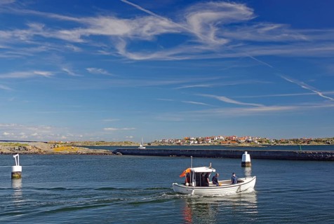 Small fishing boat in front of archipelago islands, summer, Oeckeroe, Gothenburg, Sweden, Europe