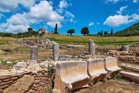 Remains of an ancient ruins site with column fragments in a green landscape, Archaeological site,