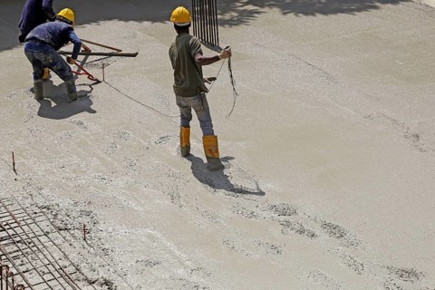Concreting a floor slab with ready-mixed concrete on the construction site of a residential