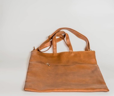 Brown leather shoulder bag with front zipper pocket isolated on white background