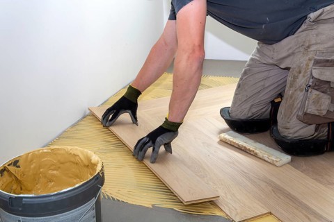 Craftsmen laying herringbone parquet professionally