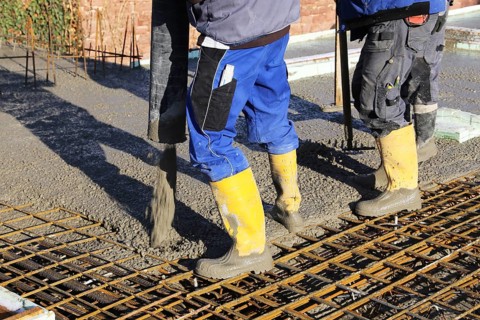 Concreting a floor slab with ready-mixed concrete on the construction site of a residential