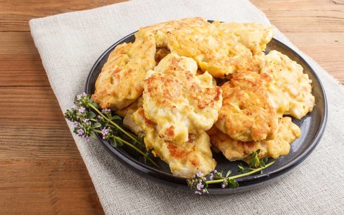 Minced chicken cutlets on brown wooden background. side view, close up