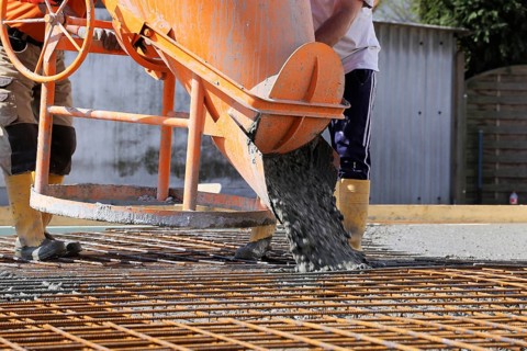 Concreting a floor slab with ready-mixed concrete on the construction site of a residential