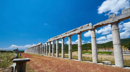 Row of columns along a paved path in an ancient archaeological site, Ancient Stadium,