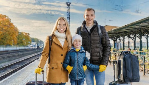 AI generated, A young family wants to travel and waits in the station for the train, 30, 35, years,