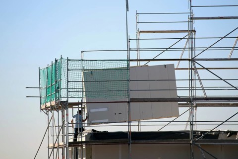 Prefabricated house under construction, the exterior walls are being delivered (Bad Duerkheim,