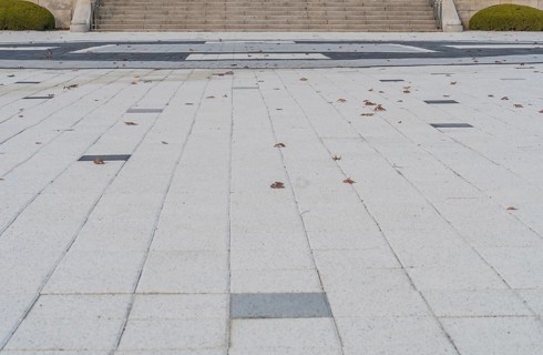 Closeup of concrete tile plaza with staircase in background in South Korea