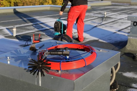 Workers from Abfluss AS clean the exhaust air ducts in an apartment block in Mannheim