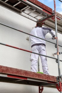 Painter painting the facade of a new residential building