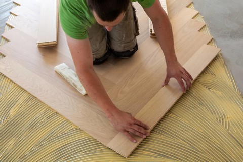 Craftsmen laying herringbone parquet professionally