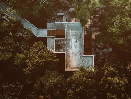 Aerial view of a secluded building among dense greenery in a forest setting, Playa del Carmen beach
