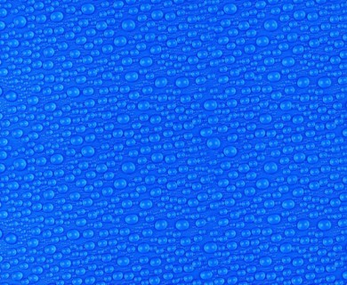 Many small water drops on a blue surface