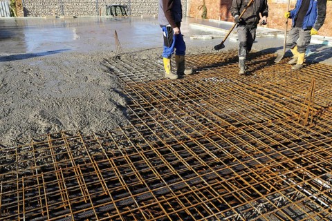 Concreting a floor slab with ready-mixed concrete on the construction site of a residential
