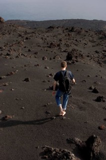 Walking barefooted over volcanic sand of the Teneguia volcano, La Palma, Canary Islands, Spain,