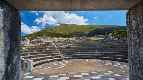 View through an arched entrance to the ruins of an ancient theatre, sanctuary of Asclepius,