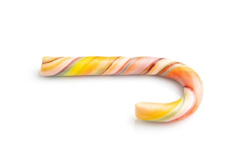 Single christmas cane candies isolated on white background. close up, side view