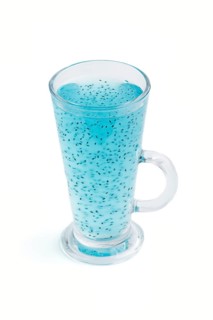 Glass of blueberry blue colored drink with basil seeds isolated on white background. Morninig,