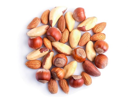 Piles of various nuts isolated on white background. hazelnut, brazil nut, almond, pumpkin seeds,