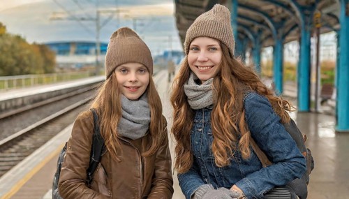 AI generated, Two young blonde woman want to travel and wait in the station for the train, 18,