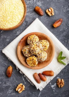 Energy ball cakes with dried apricots, sesame, cornflakes, linen, walnuts and dates with green mint