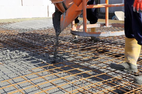 Concreting a floor slab with ready-mixed concrete on the construction site of a residential