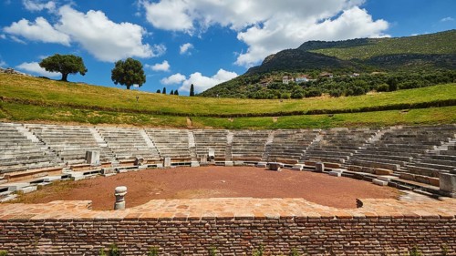 Ruins of an ancient theatre with seating steps standing out against the blue sky, Ancient theatre,