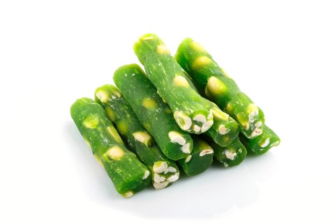 Green traditional turkish delight (rahat lokum) with peanuts isolated on white background. side