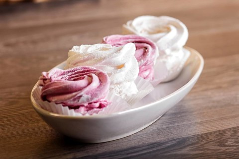Pink and white homemade marshmallows (zephyr) on a gray wooden background