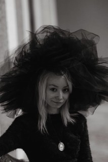 A black and white portrait captures the textured mystery of a blonde caucasian young woman's