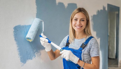 AI generated, woman, woman, a young girl paints a wall with new paint, blue, light blue, blue,