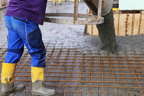 Concreting a floor slab with ready-mixed concrete on the construction site of a residential