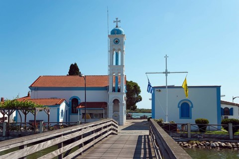 Church during the day with blue sky and access via a wooden bridge, Monastery of St Nicholas,