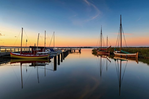 Old sailing boats in the harbour of Wieck on the Darss in the morning light