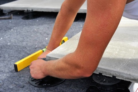Worker lays paving stones