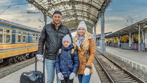 AI generated, A young family wants to travel and waits in the station for the train, 30, 35, years,