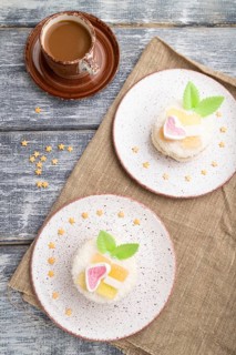 Decorated cake with milk and coconut cream with cup of coffee on a gray wooden background and linen