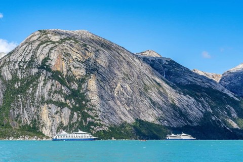 Cruise ship Stella Australis and sister ship Ventus Australis anchored between ice floes in Pia Bay