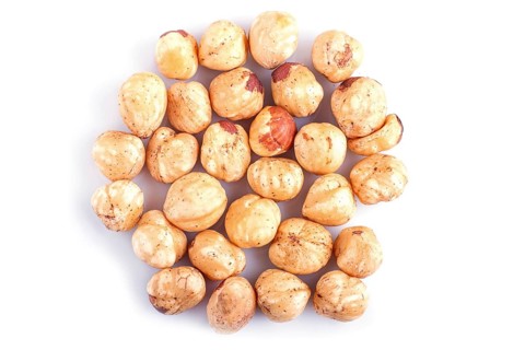 Pile of hazelnuts isolated on white background. Top view