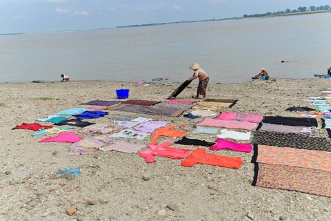 Washing clothes in the Irrawaddy, Myanmar, Asia