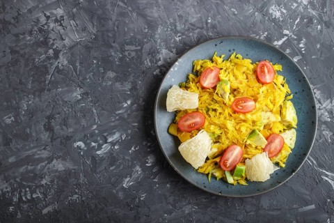 Fried pomelo with tomatoes and avocado on black concrete background. Top view, copy space, myanmar