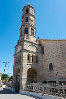 Stone church with tower clock under a clear blue sky, Greek Orthodox Church, Holy Church of Agios