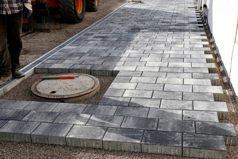 Worker lays paving stones